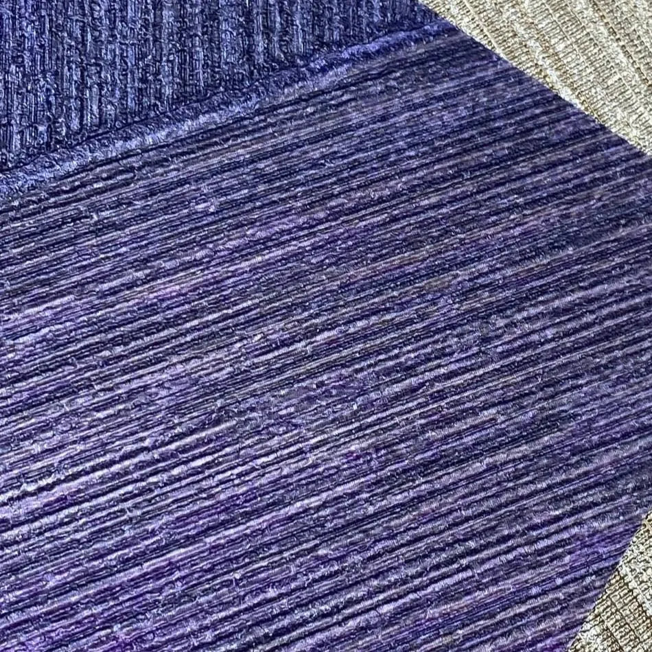 Closeup of a wallpaper showing its Contemporary, Geometric, Purple pattern, color, and subtle texture.