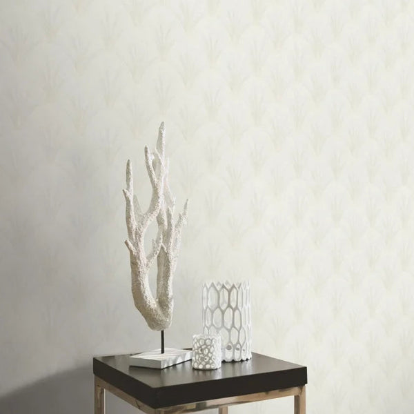 Erismann Elle Decoration light Art Deco fan wallpaper in soft white and beige tones behind a square table and center piece.
