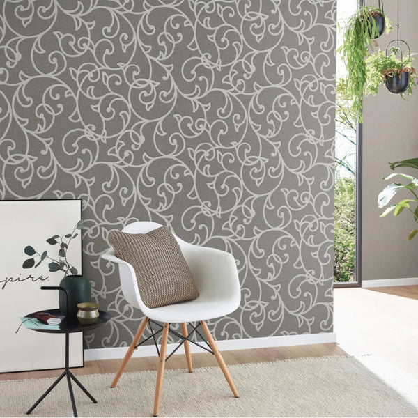 Living room with a white chair, side table, and decorative wall pattern.