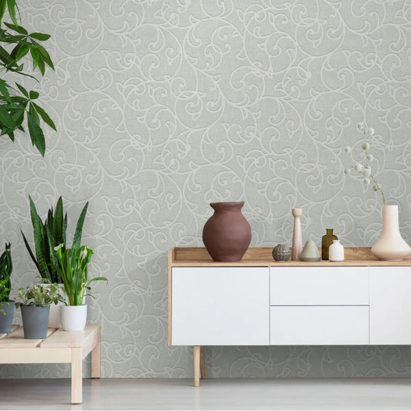 Room interior with a light gray patterned Erismann wallpaper, white cabinet, and decorative items.