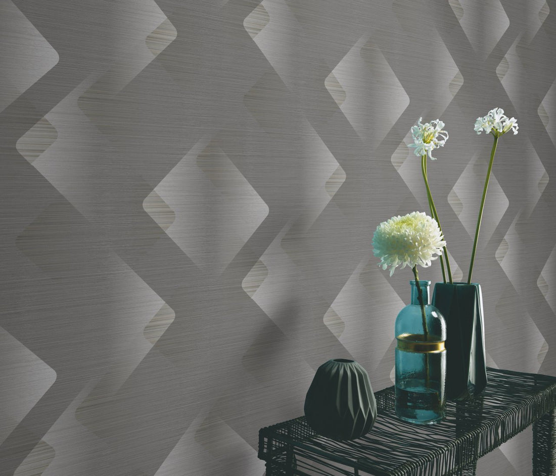 Erismann Elysium geometric wallpaper with layered diamond shapes in gray, off-white, and beige tones with a subtle textured finish.