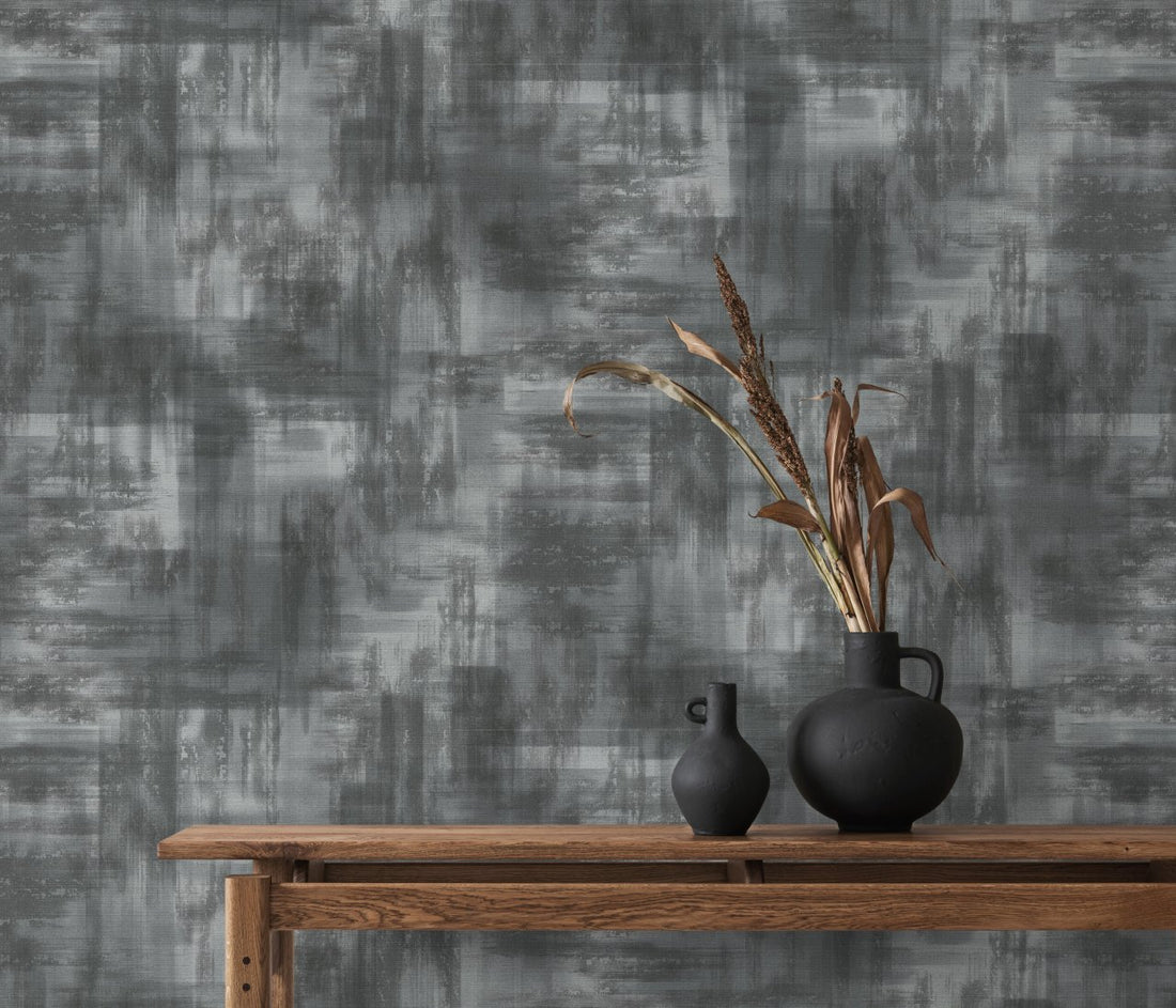 Erismann Elysium abstract wallpaper with layered block textures in shades of gray, white, and charcoal, creating a modern industrial look.