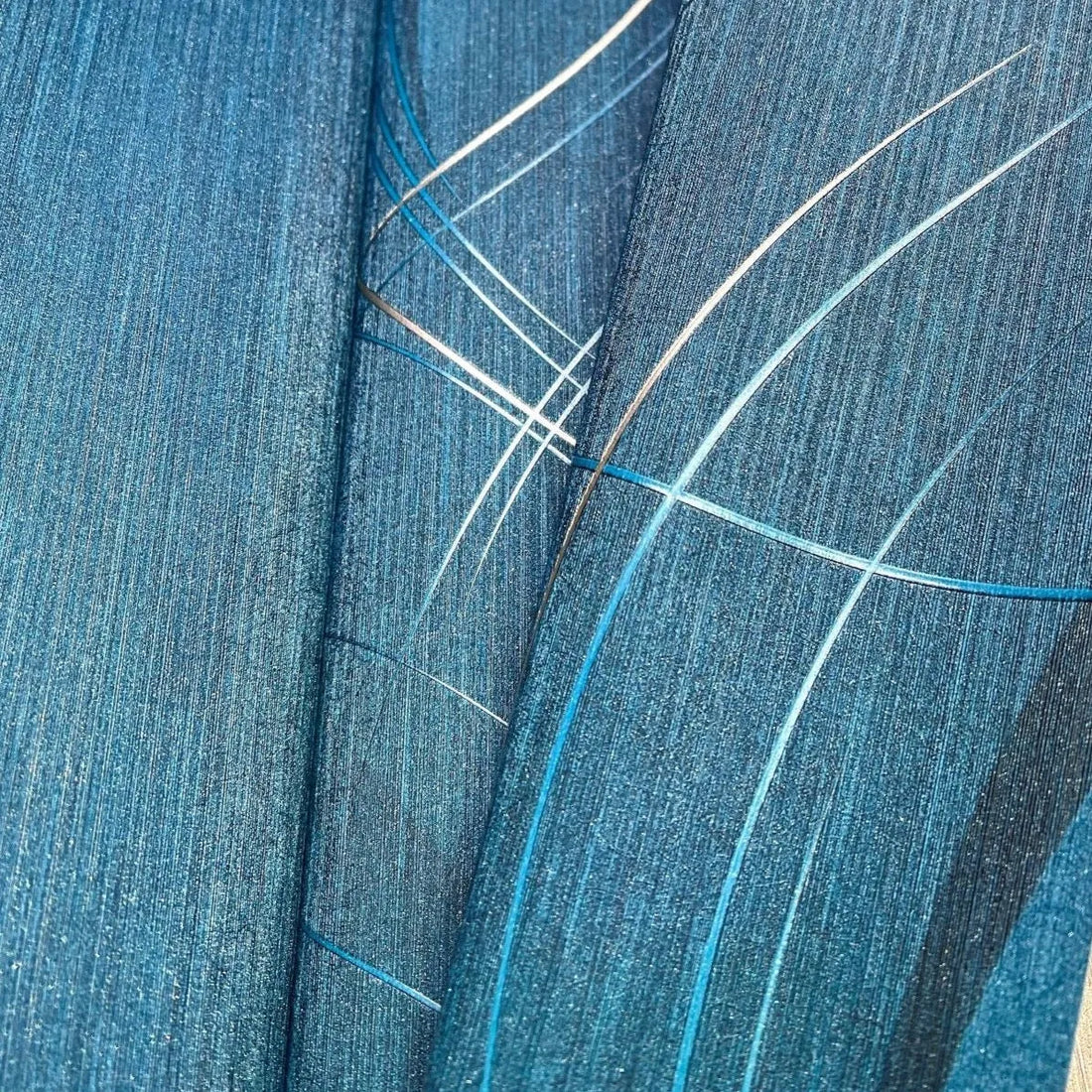 Closeup of a wallpaper showing its Blue, Contemporary, Embossed, Textures, Waves pattern, color, and subtle texture.