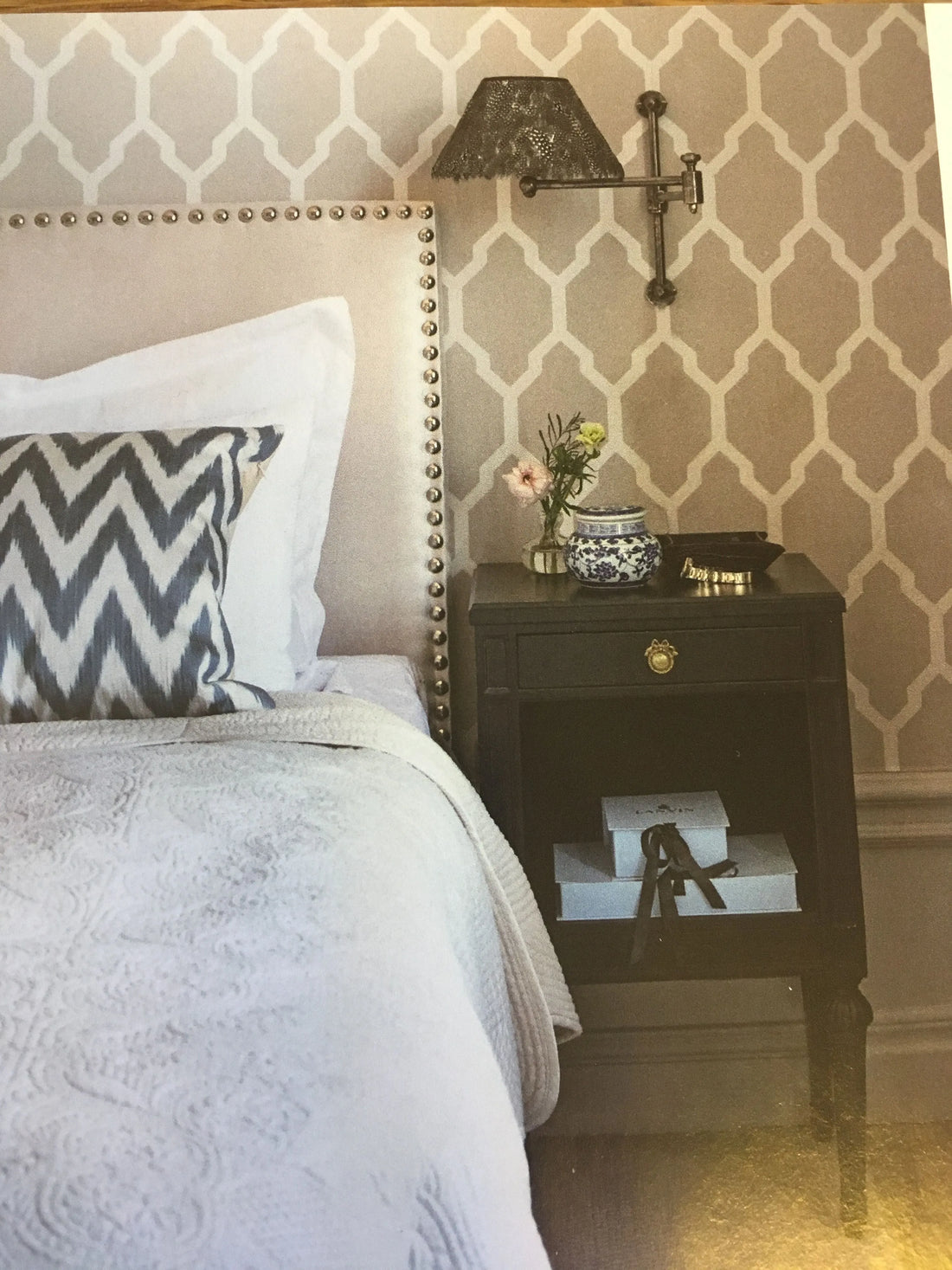 Closeup of a wallpaper showing its Contemporary, Geometric, Metallic, Trellis, Two-tone pattern, color, and subtle texture.