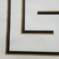 Close-up of a black and gold wallpaper on a white background