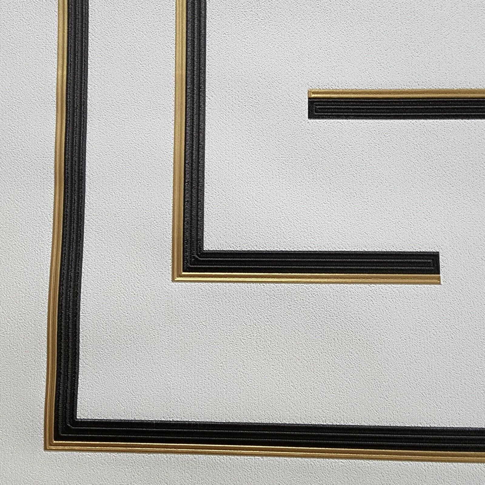 Close-up of a black and gold wallpaper on a white background