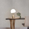 Dining area with a table, chair, and decorative items against a patterned wall.