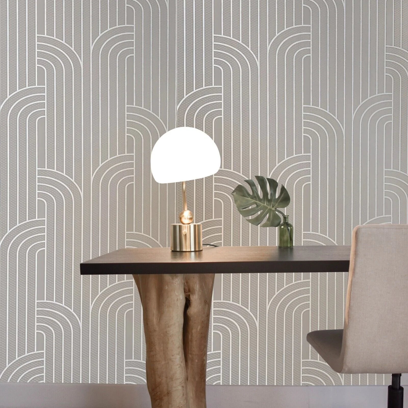 Dining area with a table, chair, and decorative items against a patterned wall.
