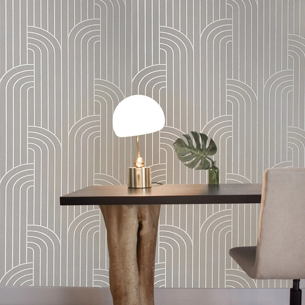 Dining area with a table, chair, and decorative items against a patterned wall.