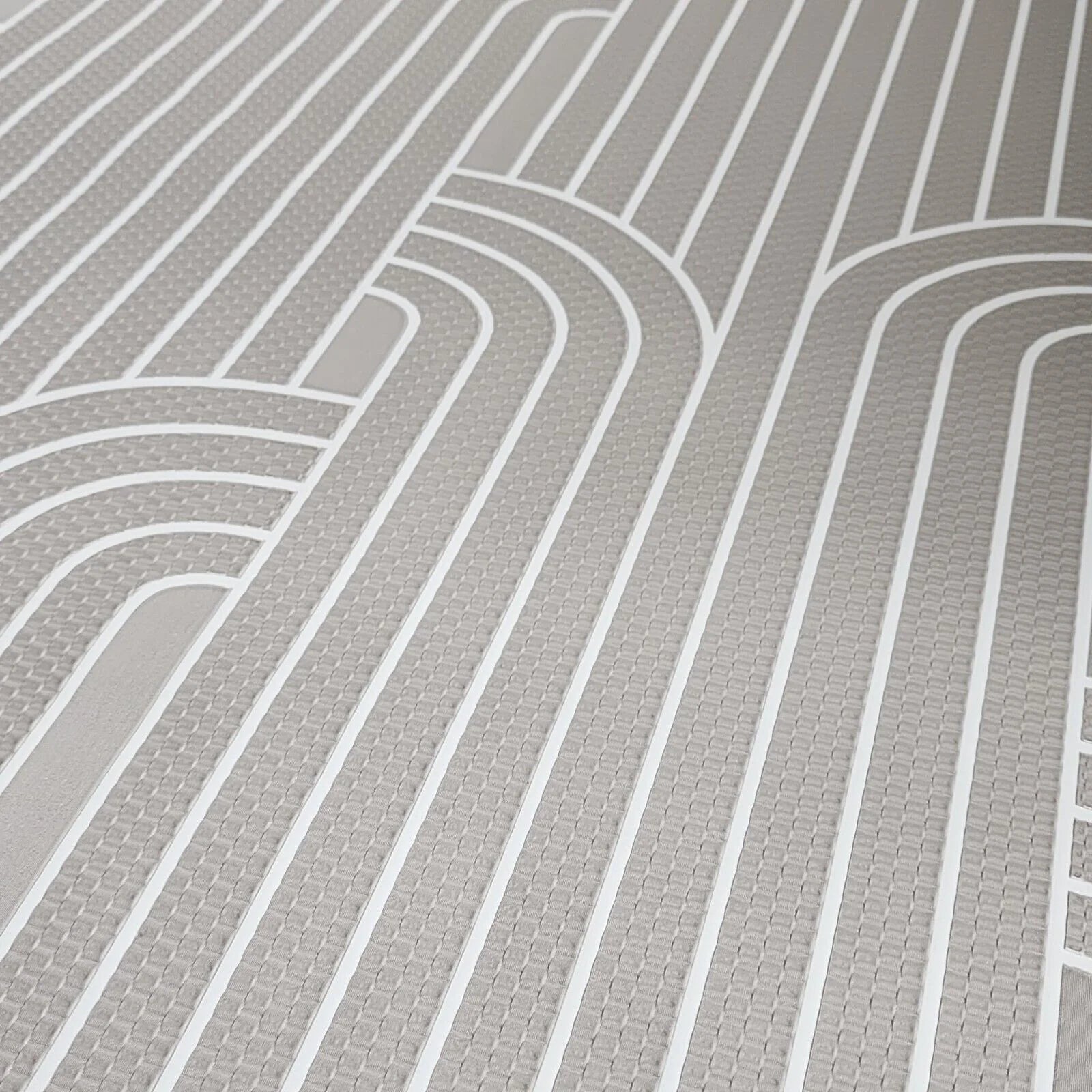 Close-up of a gray wallpaper with curved lines
