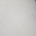 Close-up of a textured cream wallpaper with wavy lines
