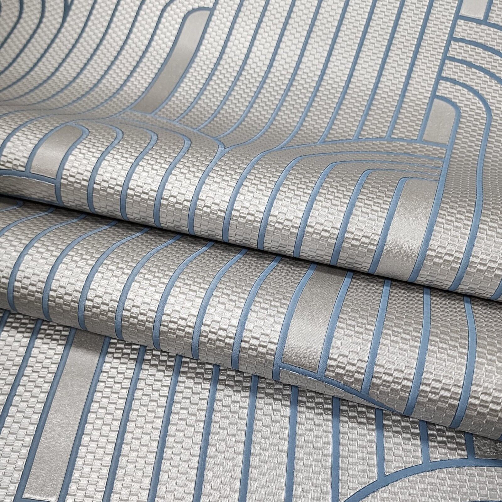 Roll of textured wallpaper with blue and gray stripes