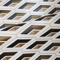 Close-up of a geometric patterned wallpaper with brown, black, and beige colors.