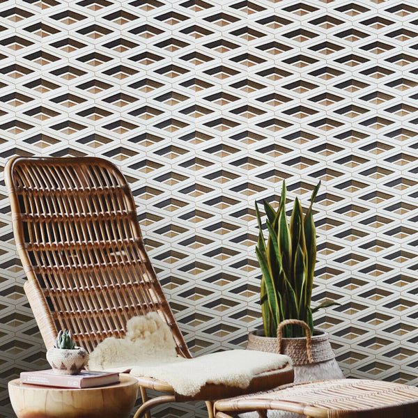 Wicker chair with ottoman and small table against a geometric patterned wall.