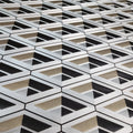 Geometric patterned wallpaper with black, white, and beige colors.