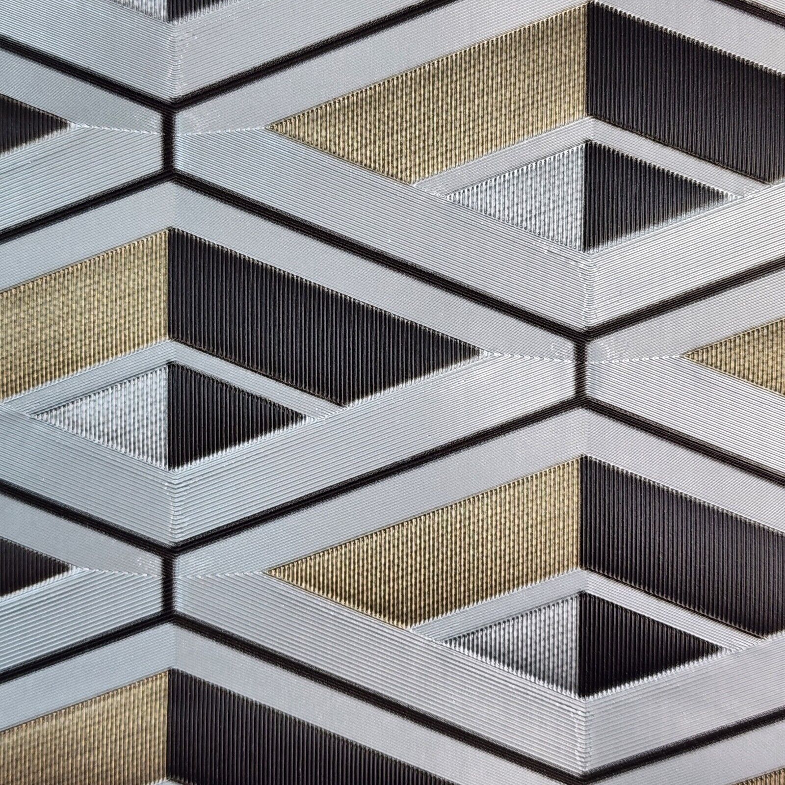 Close-up of a geometric pattern wallpaper with black, gold, and gray colors.