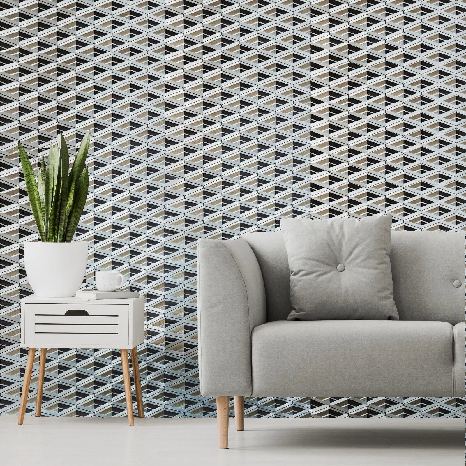 Living room with a geometric patterned wall, gray sofa, and side table.
