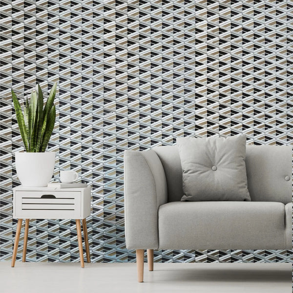 Living room with a geometric patterned wall, gray sofa, and side table.
