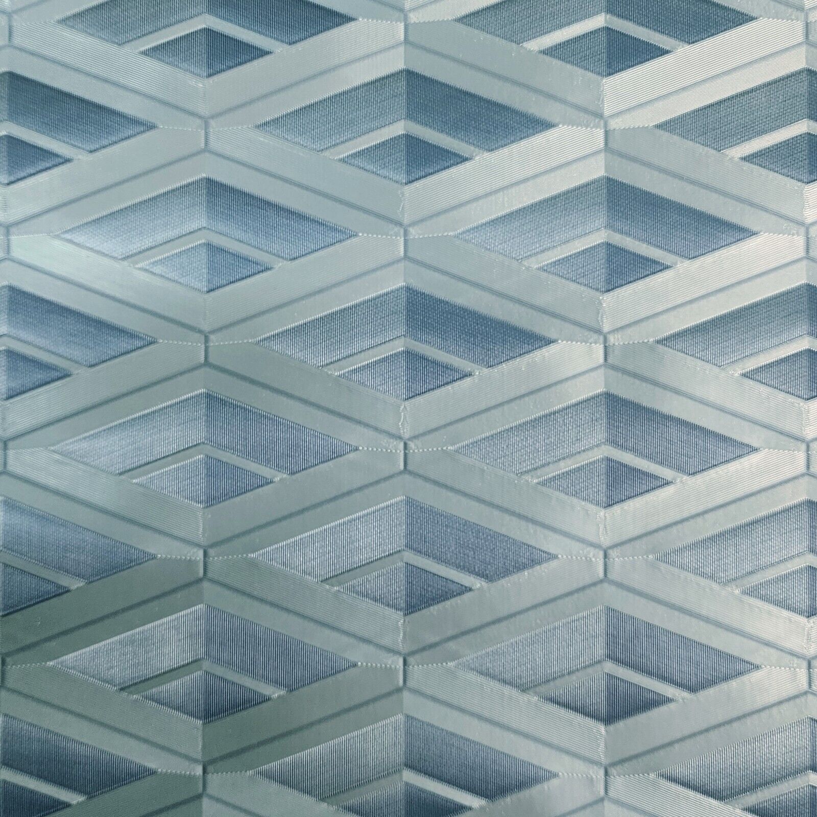 Geometric patterned wallpaper with diamond shapes in blue and gray tones.