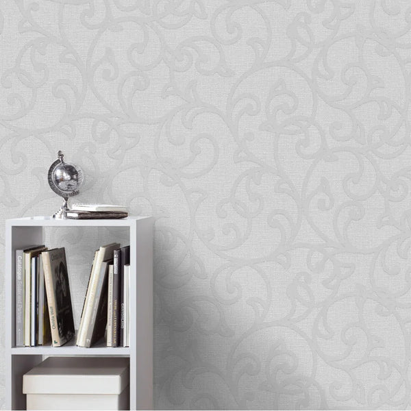 White bookshelf with books against a traditional Erismann wallpaper.