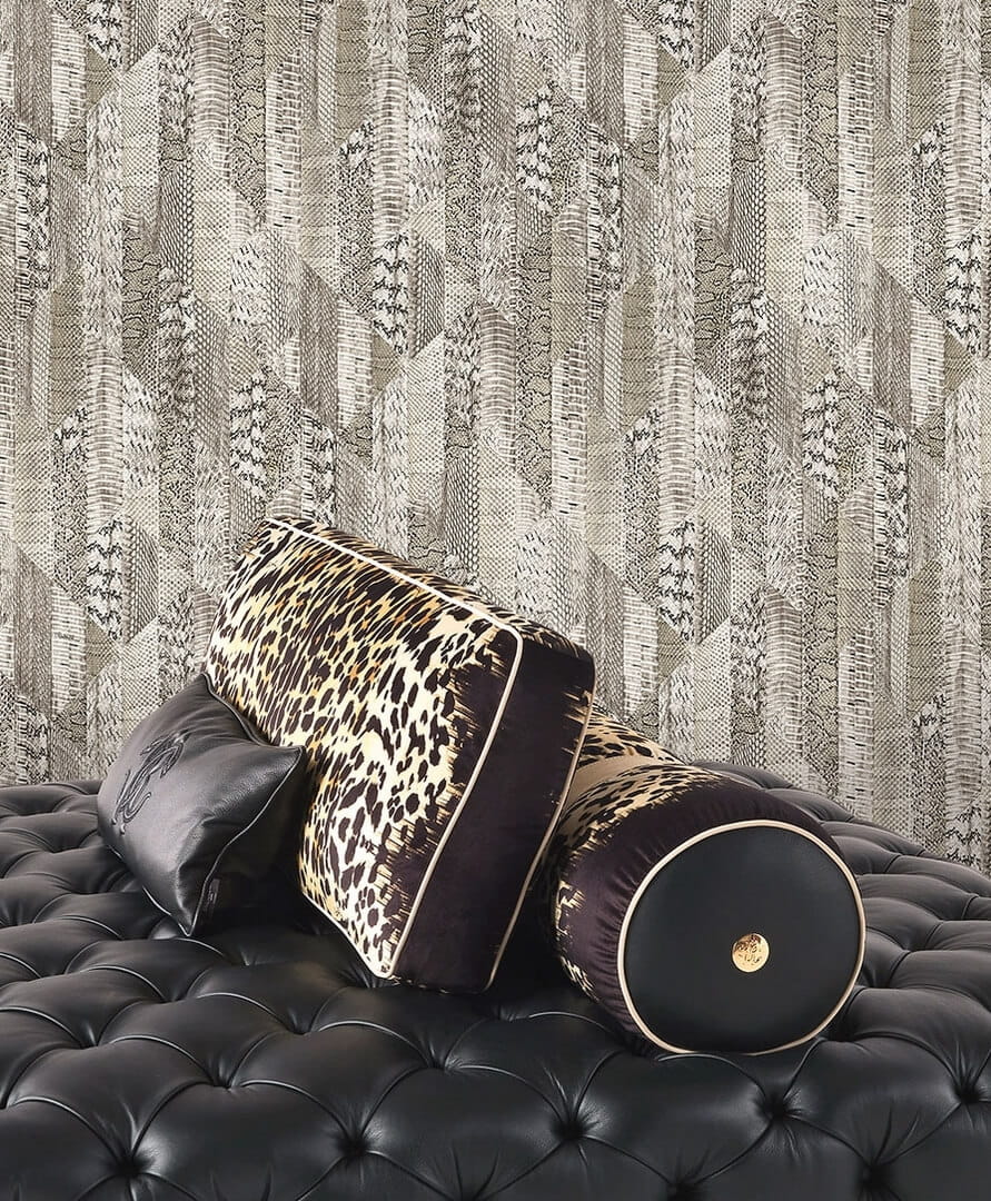 Roberto_Cavalli_RC19071 wallpaper installed on the wall behind a leather sette and Roberto Cavalli cushions