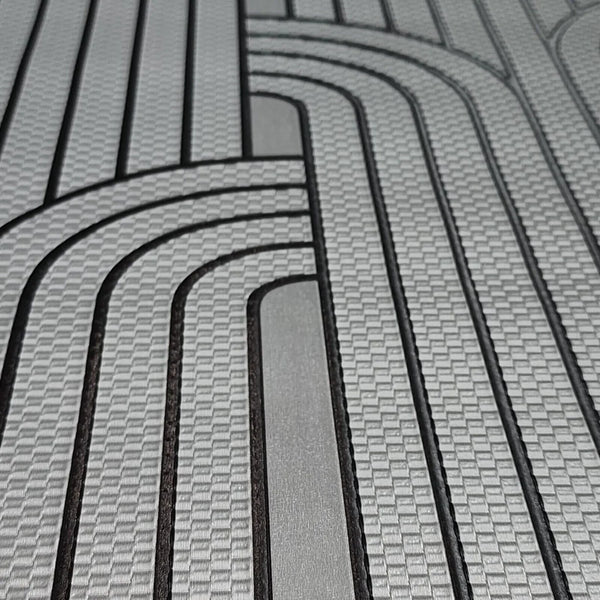 Close-up of a textured wallpaper with wavy lines in gray and black.