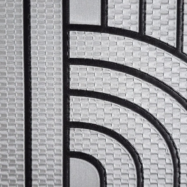 Close-up of a textured wallpaper with black lines and geometric pattern