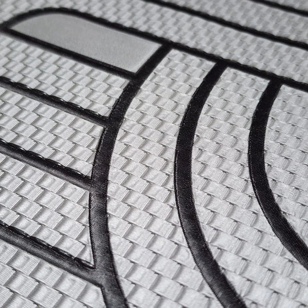 Close-up of a textured wallpaper with black lines and geometric patterns