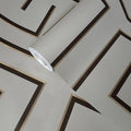 Roll of wallpaper with geometric pattern on a light gray background