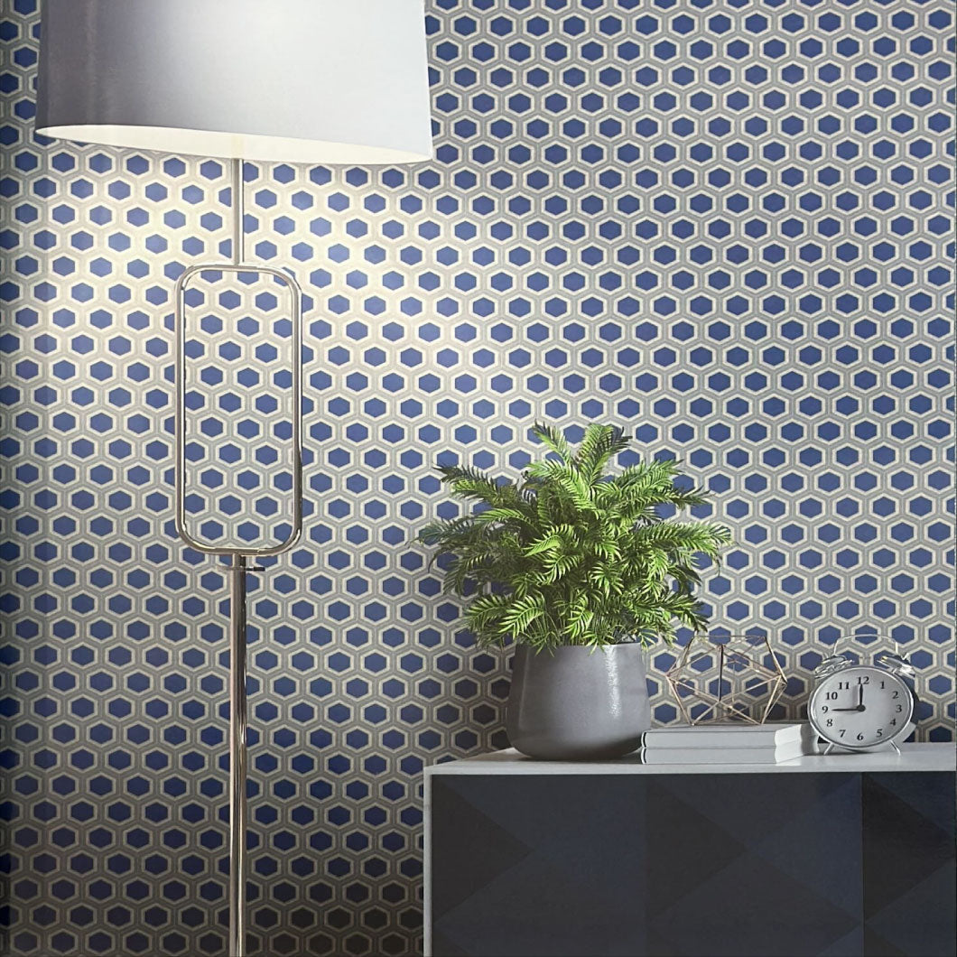 Room interior with geometric patterned wallpaper, lamp, plant, and table.