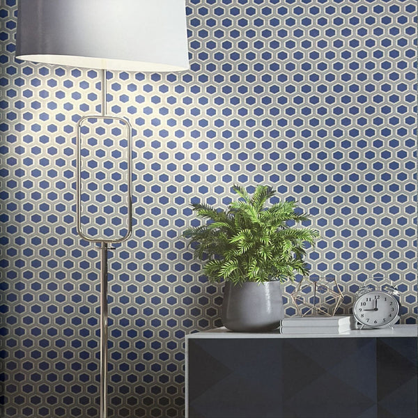Room interior with geometric patterned wallpaper, lamp, plant, and table.
