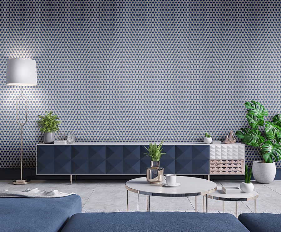 Modern living room with geometric wallpaper, blue sofa, and decorative elements.