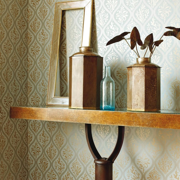 Room scene showing Anna French Francis AT1457 metallic gold ogee trellis wallpaper styled with warm accents.