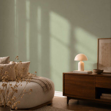 AS Creation Cosiness 792431 solid green wallpaper with a subtle fine woven texture wallpaper on a bedroom feature wall.