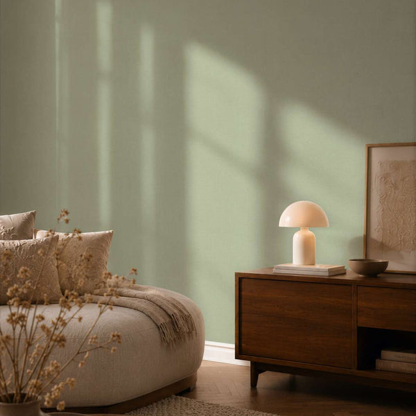 AS Creation Cosiness 792431 solid green wallpaper with a subtle fine woven texture wallpaper on a bedroom feature wall.