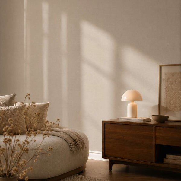 AS Creation Cosiness 792435 beige wallpaper in a living room with a wooden sideboard and a sofa.