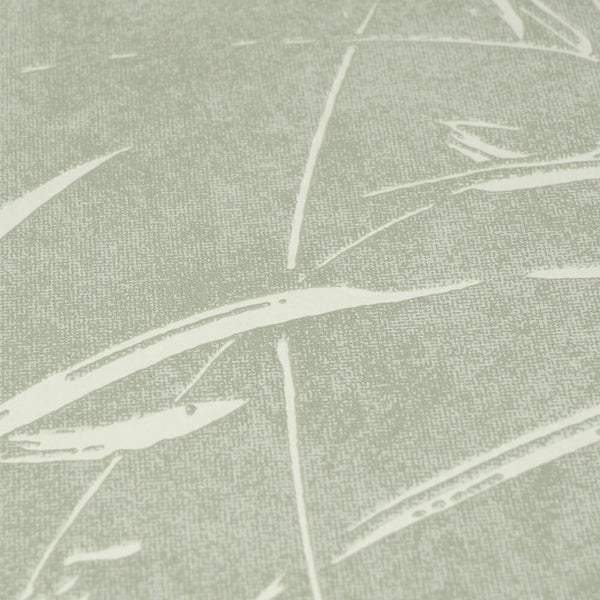 AS Creation Cosiness 792822 close up of green wallpaper with metallic accents, showing abstract sweeping leaf like lines over a speckled ground.
