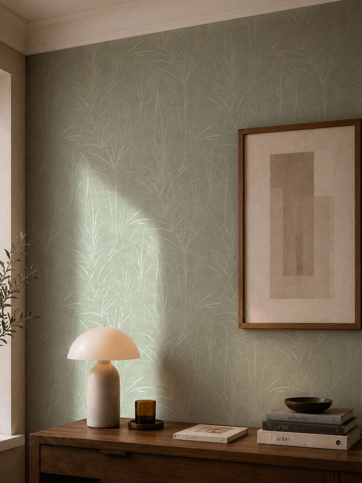 AS Creation Cosiness 792822 green, Metallic botanical wallpaper behind a console with a dome table lamp and framed artwork.