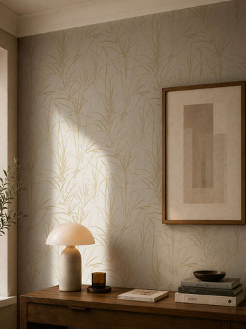 AS Creation Cosiness 792823 botanical reed pattern wallpaper in Brown, Cream, and Metallic shown behind a wood console with a dome table lamp and framed artwork.