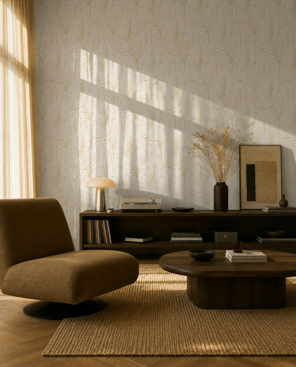 AS Creation Cosiness 792823 living room with Brown, Cream, Metallic wallpaper featuring a delicate leafy motif, shown behind a modern armchair and a low coffee table.