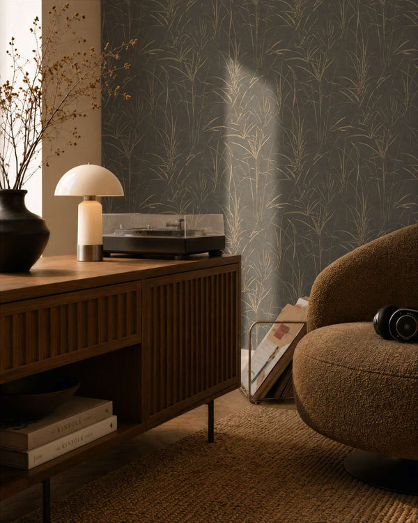 AS Creation Cosiness 792825 living room with wallpaper featuring a botanical pattern in Brown, Grey, and Metallic, with a wooden sideboard and a rounded armchair.