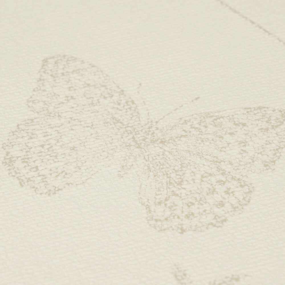 AS Creation Cosiness 792831 close up of beige and brown wallpaper featuring a softly sketched butterfly motif with subtle texture.