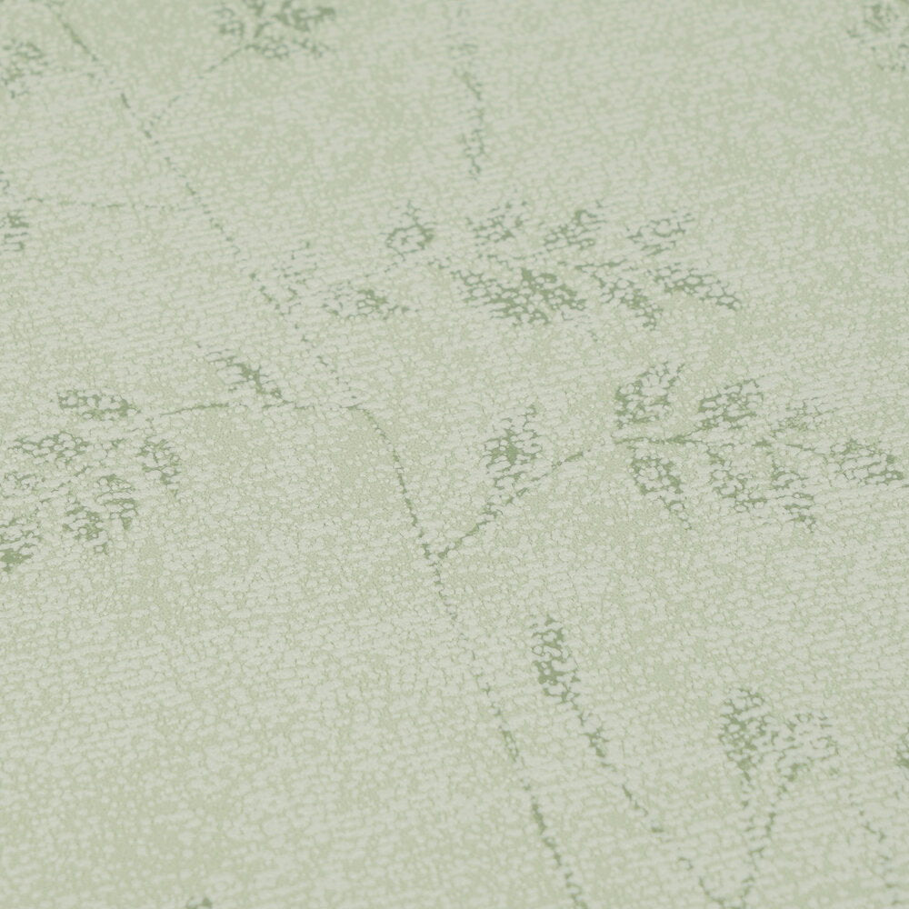 AS Creation Cosiness 792833 beige and brown speckled wallpaper with delicate leaf silhouettes forming a subtle botanical pattern close up showing the surface texture and pattern detail.