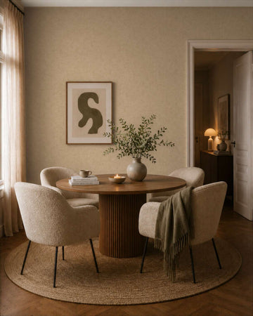 AS Creation Cosiness 792841 dining room with subtle mottled wallpaper, a round table and upholstered chairs.