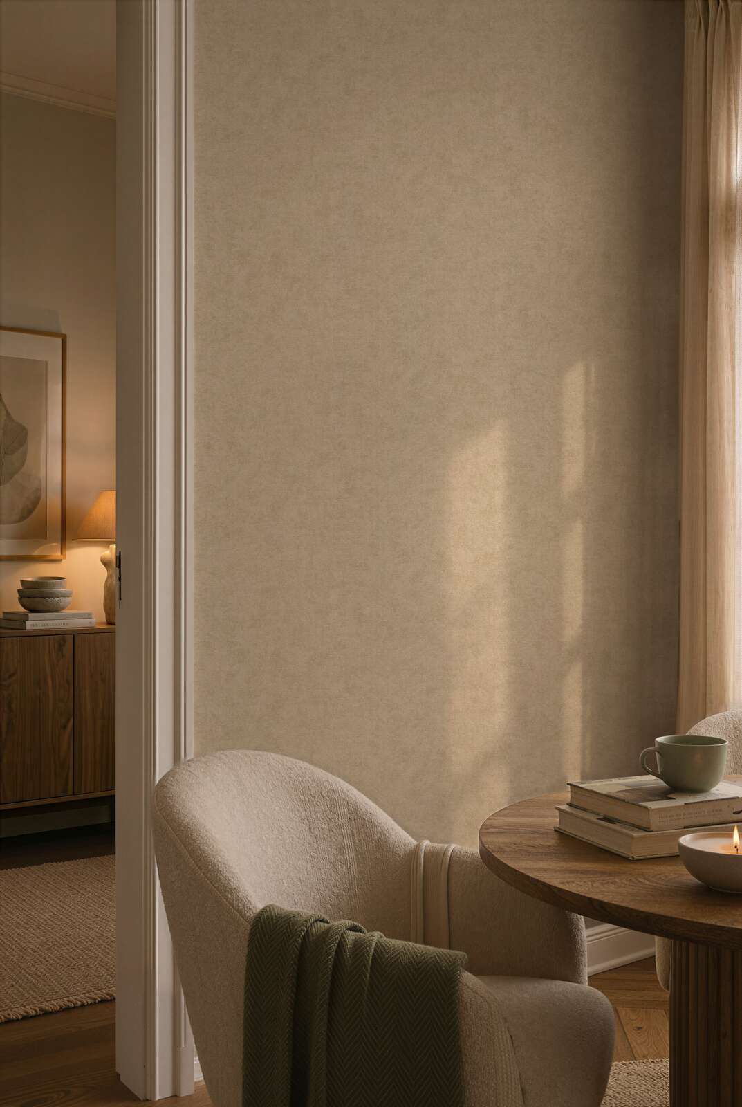 AS Creation Cosiness 792841 living room with tonal mottled wallpaper, a round table and an upholstered armchair.