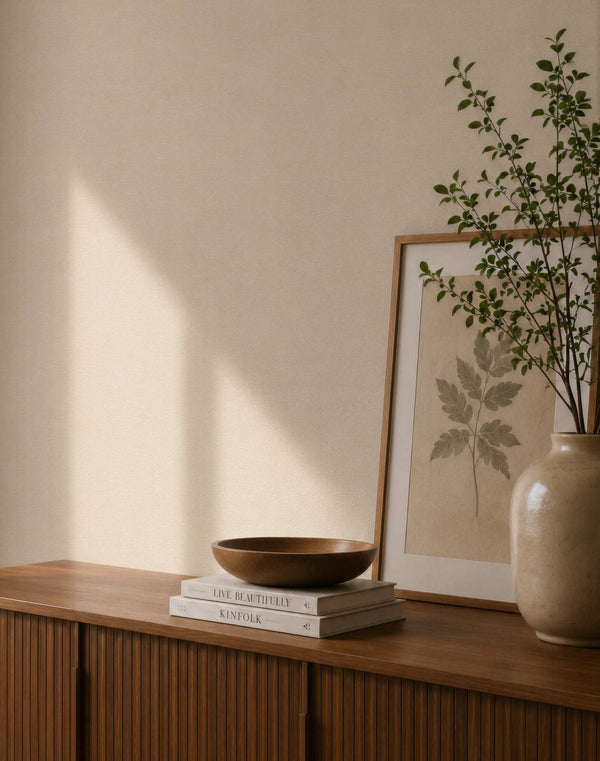 AS Creation Cosiness 792843 neutral plain wallpaper with a subtle tonal texture in beige and cream shown in a styled detail.