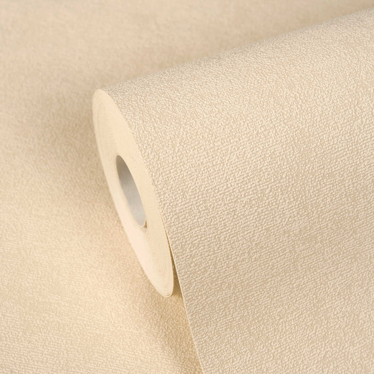AS Creation Cosiness 792843 close up of a textured wallpaper roll in the Beige, Brown, Cream colorway, resting on an unrolled sheet of the same design.