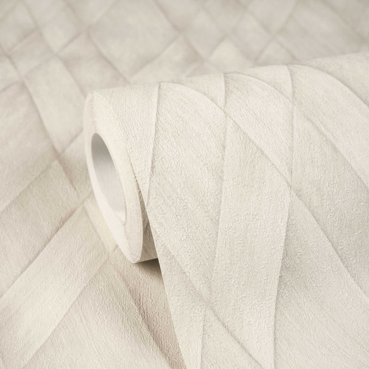 AS Creation Cosiness 793132 close up of a wallpaper roll resting on matching material, showing a geometric overlapping band pattern in Grey, White.