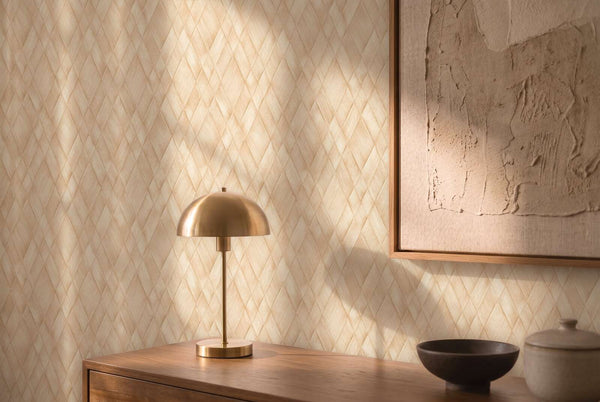 AS Creation Cosiness 793133 styled detail of Beige and Cream wallpaper with a diamond lattice pattern behind a dome table lamp and framed artwork on a console.