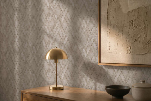 AS Creation Cosiness 793135 brown and Grey geometric wallpaper with an overlapping diamond pattern behind a brass dome table lamp on a wood console and a framed textured artwork.